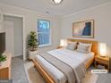 Cozy staged bedroom with a plush rug, a serene ambiance, and natural light at 483 Fairlane Nw Cir, Atlanta, GA 30331