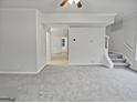 Neutral walls, plush carpet, and stairs leading to the next level create a cozy living space at 483 Fairlane Nw Cir, Atlanta, GA 30331