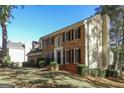 Charming brick home with black shutters and a well maintained lawn, under a bright blue sky at 105 Windridge Dr, Fayetteville, GA 30215