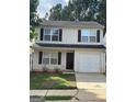 Traditional two-story home with a garage and neutral-toned siding offers great curb appeal at 187 London Dr, Mcdonough, GA 30253