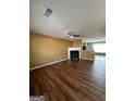 Spacious living room with hardwood floors and a cozy fireplace provides a welcoming atmosphere at 187 London Dr, Mcdonough, GA 30253
