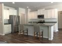 Modern kitchen featuring white cabinets, stainless steel appliances, and a center island with barstool seating at 85 Crabapple Ridge Dr, Oxford, GA 30054