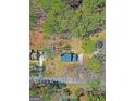 Aerial view of a house with a dark blue roof, surrounded by trees and greenery at 175 Ashley Dr, Fayetteville, GA 30214