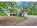 A charming home with a two-car garage and a well-manicured lawn lined with bushes at 175 Ashley Dr, Fayetteville, GA 30214
