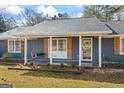 Inviting front porch with a swing, classic wooden shutters, and well-maintained landscaping at 850 Coan Dr, Locust Grove, GA 30248