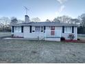 Cozy single-story home featuring a brick exterior, black shutters, and front porch entry at 20 Maddox Dr, Locust Grove, GA 30248