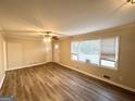 Spacious living room with hardwood flooring, a ceiling fan, and ample natural light at 20 Maddox Dr, Locust Grove, GA 30248
