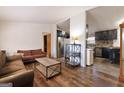 Bright living room showcasing hardwood floors, comfortable sofas, and an open floor plan leading to the kitchen at 105 Woodfield Rd, Covington, GA 30014