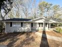 This single-story home features a carport, light brick, and black shutters at 3558 Turner Heights Dr, Decatur, GA 30032