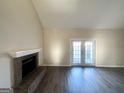 Living room featuring a brick fireplace, wood-look flooring, and access to a patio at 4517 Golf Vista Cir, Decatur, GA 30035