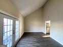 Spacious living room featuring vaulted ceilings, wood-look flooring and access to a patio at 4517 Golf Vista Cir, Decatur, GA 30035