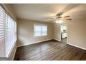 Bright living room featuring sleek flooring, fresh paint, large window, and a ceiling fan at 2000 Marvin Sw Ln, Atlanta, GA 30311
