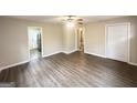 Spacious living room with wood floors, ceiling fan, and entry to kitchen at 2000 Marvin Sw Ln, Atlanta, GA 30311
