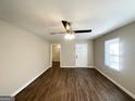 Inviting living room with laminate flooring and ceiling fan, showcasing the freshly painted interior at 2191 Tilson Cir, Decatur, GA 30032