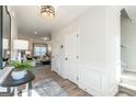 Bright entryway featuring a stylish console table with decor leading to the stairs and living area at 10453 Trellis Lane (Lot 28), Hampton, GA 30228