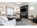 Inviting living room with modern fireplace, plush seating, and stylish decor for relaxing at 10453 Trellis Lane (Lot 28), Hampton, GA 30228