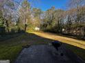 Spacious backyard featuring a stone patio with a grill, perfect for outdoor gatherings and summer barbecues at 120 Wayside Dr, Lawrenceville, GA 30046