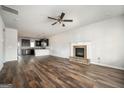 Open living room featuring hardwood floors, a fireplace, and a ceiling fan at 220 Long Dr, Mcdonough, GA 30253