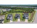 Neighborhood aerial view of single-Gathering homes, lush yards, and mature trees at 104 Conway St, Peachtree City, GA 30269