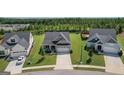 Ariel view of single-Gathering home with a two-car garage, a manicured lawn, and a lush green yard at 104 Conway St, Peachtree City, GA 30269
