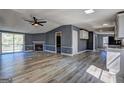 Spacious living room with a fireplace, ceiling fan and sliding door leading to outdoor deck at 152 Skyland E Dr, Locust Grove, GA 30248