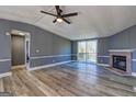 Open-concept living room with a fireplace and sliding glass doors to the outside deck at 152 Skyland E Dr, Locust Grove, GA 30248