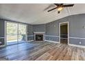 Bright living room featuring a fireplace and sliding glass doors to the outside deck at 152 Skyland E Dr, Locust Grove, GA 30248