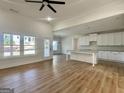 Inviting living room flows into kitchen, boasting wood floors and ample natural light at 6149 Se Pinewood Dr, Covington, GA 30014