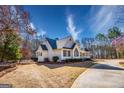 Exterior view showcasing the side and front of a home, complemented by a well-maintained lawn at 3140 Cox Cemetery Rd, Social Circle, GA 30025