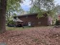 Spacious backyard featuring a covered patio area, perfect for outdoor entertaining and relaxation at 6826 Mayo Dr, Riverdale, GA 30274