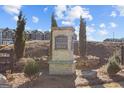 Stone sign for 'The Enclave at Azalea Hills' surrounded by landscaped grounds and townhomes at 223 Ivey Ter # 34, Temple, GA 30179