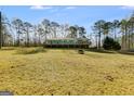 A cozy home with a large deck, surrounded by beautiful trees and a well-maintained grassy lawn at 4864 Yeagar Rd, Douglasville, GA 30135