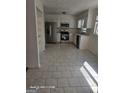 Bright kitchen with stainless steel appliances, white cabinetry, and tile flooring at 11187 Shannon Cir, Hampton, GA 30228