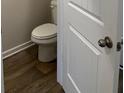 A clean powder room featuring a white toilet and gray walls at 231 Ivey Ter # 38, Temple, GA 30179