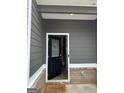 Covered front porch and welcome mat at the entrance of the home at 233 Ivey Ter # 39, Temple, GA 30179
