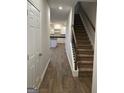 Hallway featuring wood-look flooring and stairs leading to the upper level at 233 Ivey Ter # 39, Temple, GA 30179