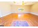 Open living room features wood floors, a window with a view, and a unique tile accent at 8684 Chestnut Ln, Lithia Springs, GA 30122