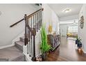 Inviting entryway with hardwood floors, staircase, and stylish decor at 88 Hardy Water Dr, Lawrenceville, GA 30045