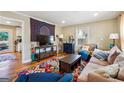 Comfortable living room featuring hardwood floors, colorful rug and a decorative wall hanging at 2114 Fellowship Rd, Tucker, GA 30084
