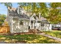 Charming home with shingle siding, dormer windows, and inviting brick steps at 1471 Hardin Ave, College Park, GA 30337