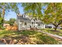 Charming home with manicured lawn, shingle siding, and dormer windows at 1471 Hardin Ave, College Park, GA 30337