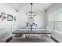 Bright dining room with high ceilings, featuring a rustic table and a modern chandelier at 624 Bexley Rd, Moreland, GA 30259