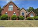 A brick and stone home with a well-manicured lawn and trimmed bushes enhance curb appeal at 1209 Persimmon Way, Mcdonough, GA 30252