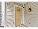 Close-up of a townhouse entrance featuring a light yellow door and classic exterior details at 1379 Keys Lake Ne Dr, Brookhaven, GA 30319