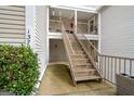 Exterior view of a townhouse featuring stairs leading to an upper unit and well-kept landscaping at 1379 Keys Lake Ne Dr, Brookhaven, GA 30319