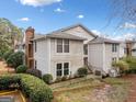 Exterior view of a two-story townhouse featuring neutral siding and well-maintained landscaping at 1379 Keys Lake Ne Dr, Brookhaven, GA 30319