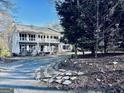 Traditional home with double porches, set amongst mature trees and an inviting walkway at 114 Rolling Grn, Peachtree City, GA 30269