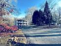 A winding driveway leads to this charming, traditionally-styled home, surrounded by trees at 114 Rolling Grn, Peachtree City, GA 30269