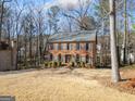 Charming two-story brick home featuring blue shutters and a spacious front yard at 505 Summer Ter, Woodstock, GA 30189