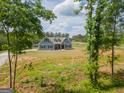 Secluded two-story home with blue siding and black shutters, framed by lush trees at 296 Beavers Rd, Grantville, GA 30220